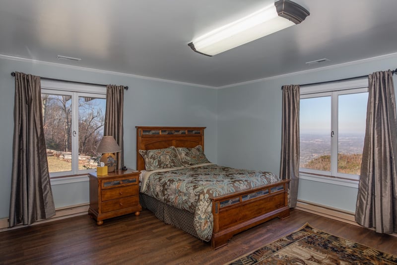 Bedroom with a large bed and nightstand at Best View Ever A 5 bedroom cabin rental in Pigeon Forge