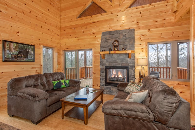 Living room with see through fireplace at Happy Bears Hideaway, a 2 bedroom cabin rental located in Gatlinburg