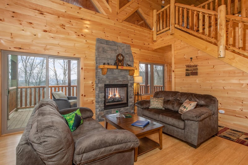 Living room with see through fireplace at Happy Bears Hideaway, a 2 bedroom cabin rental located in Gatlinburg