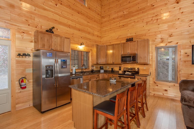 Kitchen with stainless appliances and breakfast bar at Happy Bears Hideaway, a 2 bedroom cabin rental located in Gatlinburg