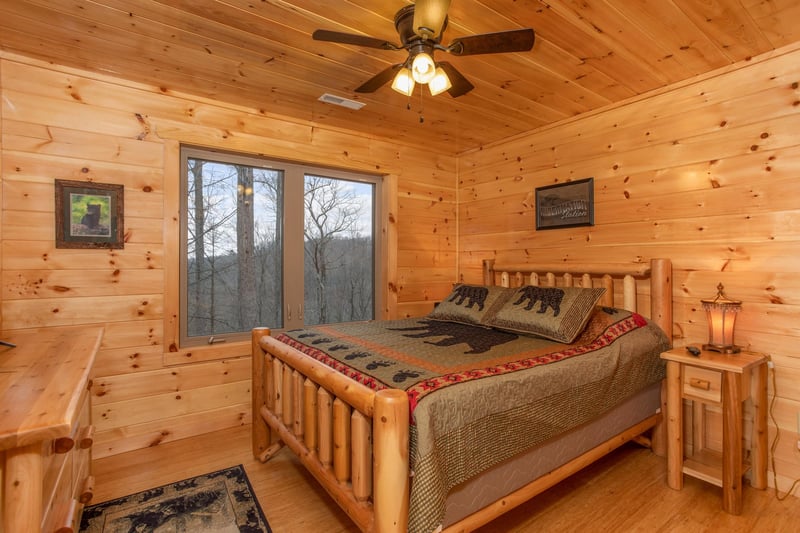 Bedroom with king bed and night stand at Happy Bears Hideaway, a 2 bedroom cabin rental located in Gatlinburg