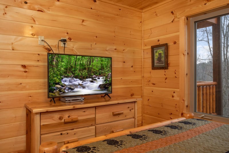 Dresser and TV in a bedroom at Happy Bears Hideaway, a 2 bedroom cabin rental located in Gatlinburg