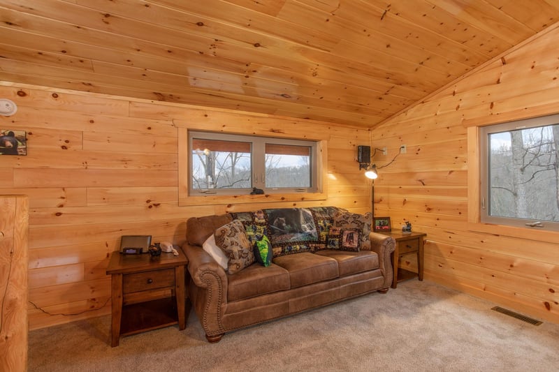 Queen sleeper sofa in the living room at Happy Bears Hideaway, a 2 bedroom cabin rental located in Gatlinburg