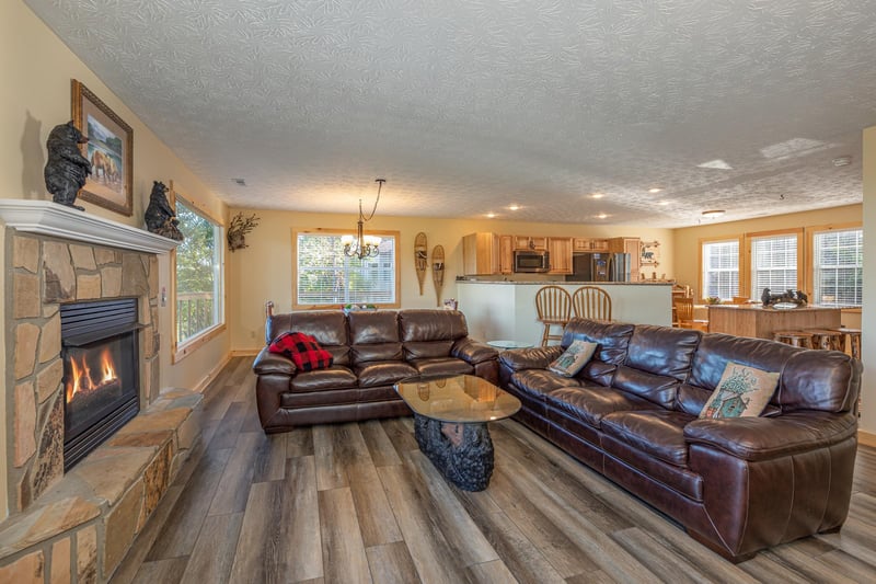 Living room with sofas and a fireplace at Le Bear Chalet, a 7 bedroom cabin rental located in Gatlinburg