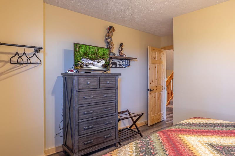 Dresser and TV in a bedroom at Le Bear Chalet, a 7 bedroom cabin rental located in Gatlinburg