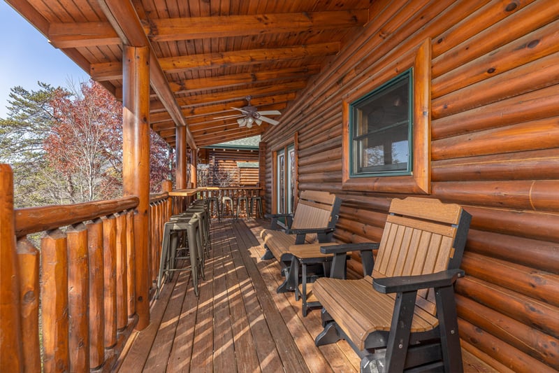 Bar stools  benches on a deck at Loving Every Minute, a 5 bedroom cabin rental located in Pigeon Forge