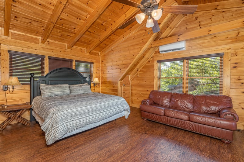 Master king room with sleeper sofa at Loving Every Minute, a 5 bedroom cabin rental located in Pigeon Forge