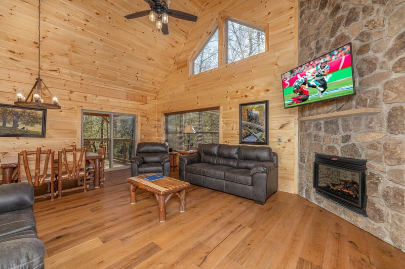 Living room and dining room with fireplace  tv at Bessy Bears Cabin, a 2 bedroom cabin rental located inGatlinburg