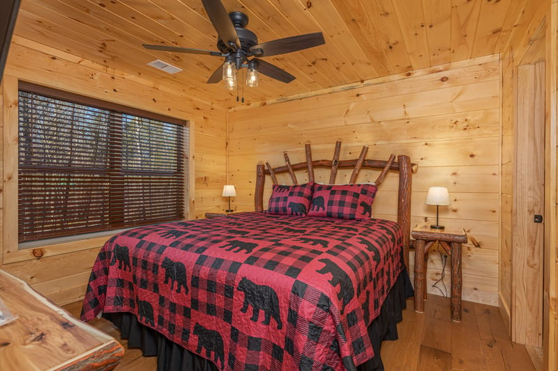 Bedroom with a bed, two night stands, and lamps at Bessy Bears Cabin, a 2 bedroom cabin rental located inGatlinburg