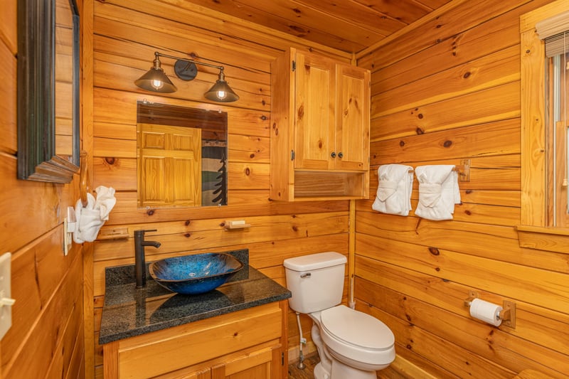 A bathroom with a custom sink at Moonlit Pines, a 2 bedroom cabin rental located in Pigeon Forge