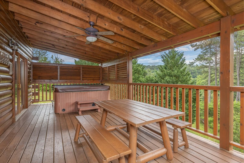 Picnic Table on Covered Deck at Almost Bearadise, a 4 bedroom cabin rental located in Pigeon Forge