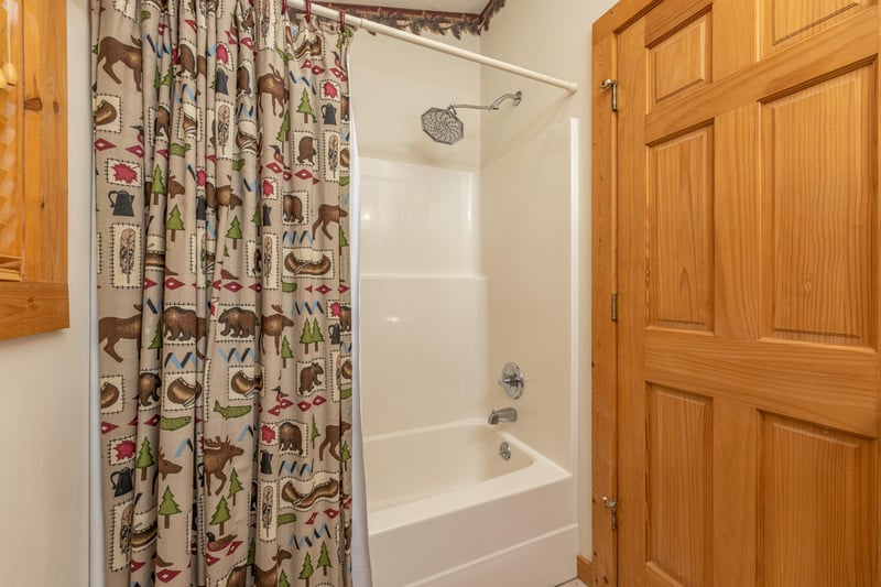 Bathroom with a tub and shower at Cubs Crossing, a 3 bedroom cabin rental located in Gatlinburg