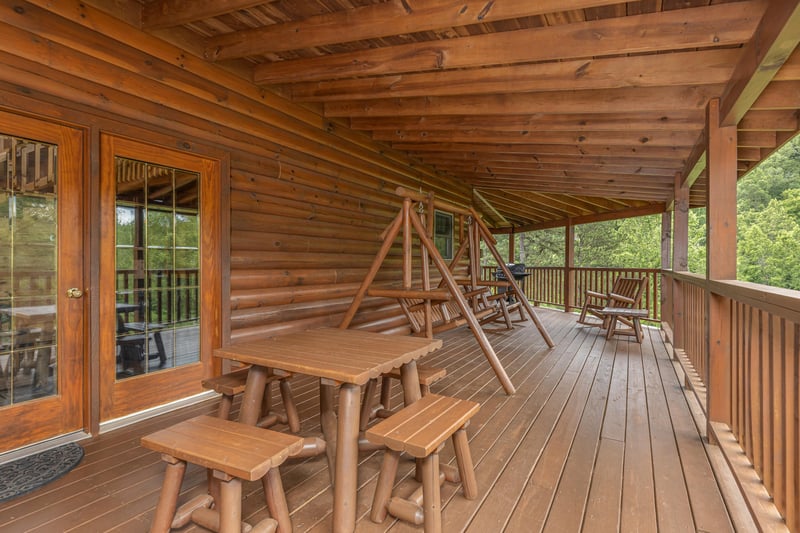 Seating on Covered Deck at Almost Bearadise, a 4 bedroom cabin rental located in Pigeon Forge