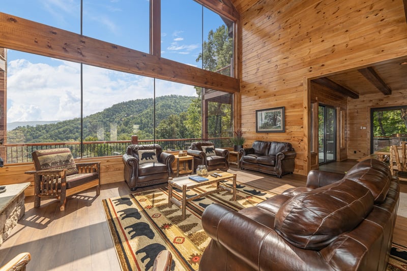 Living room with lots of seating and large windows at Black Bears  Biscuits Lodge, a 6 bedroom cabin rental located in Pigeon Forge