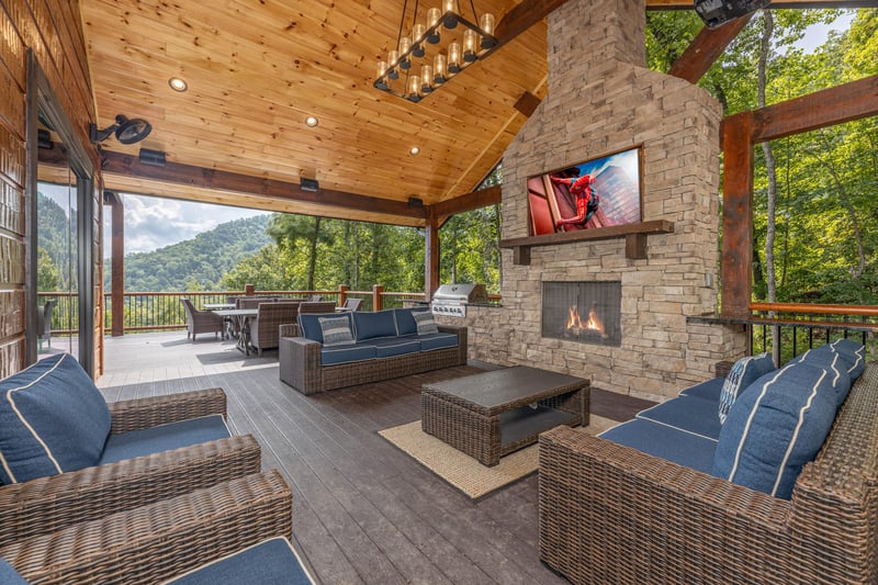 Outdoor seating area with a fireplace and TV at Black Bears  Biscuits Lodge, a 6 bedroom cabin rental located in Pigeon Forge