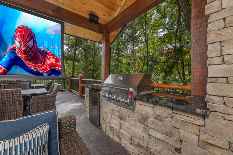 Theater screen and outdoor kitchen at Black Bears  Biscuits Lodge, a 6 bedroom cabin rental located in Pigeon Forge