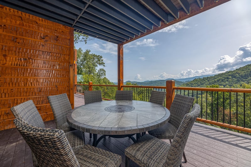 Outdoor dining space for 8 at Black Bears  Biscuits Lodge, a 6 bedroom cabin rental located in Pigeon Forge