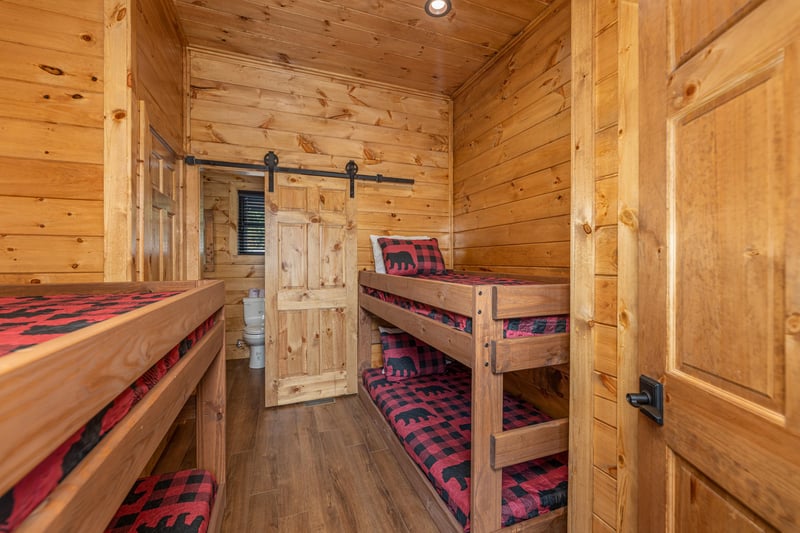 Bedroom with four twin bunk beds at Black Bears  Biscuits Lodge, a 6 bedroom cabin rental located in Pigeon Forge