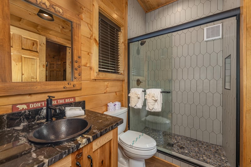 Bathroom with a walk in shower at Black Bears  Biscuits Lodge, a 6 bedroom cabin rental located in Pigeon Forge