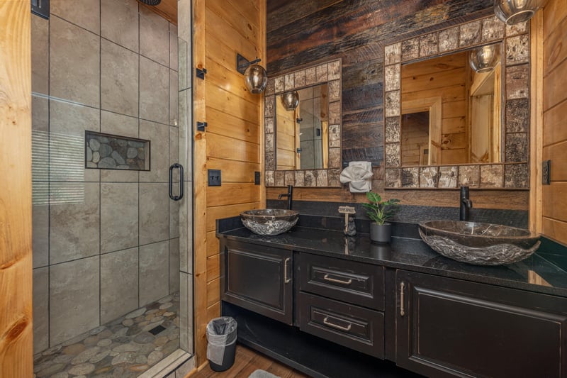 Bathroom with double sinks and large shower at Black Bears  Biscuits Lodge, a 6 bedroom cabin rental located in Pigeon Forge