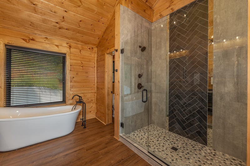 Bathroom with a soaker tub and walk in shower at Black Bears  Biscuits Lodge, a 6 bedroom cabin rental located in Pigeon Forge