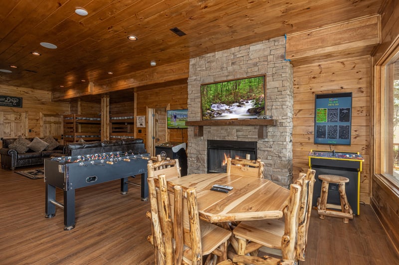 Game room with foosball, arcade game, and poker table at Black Bears  Biscuits Lodge, a 6 bedroom cabin rental located in Pigeon Forge