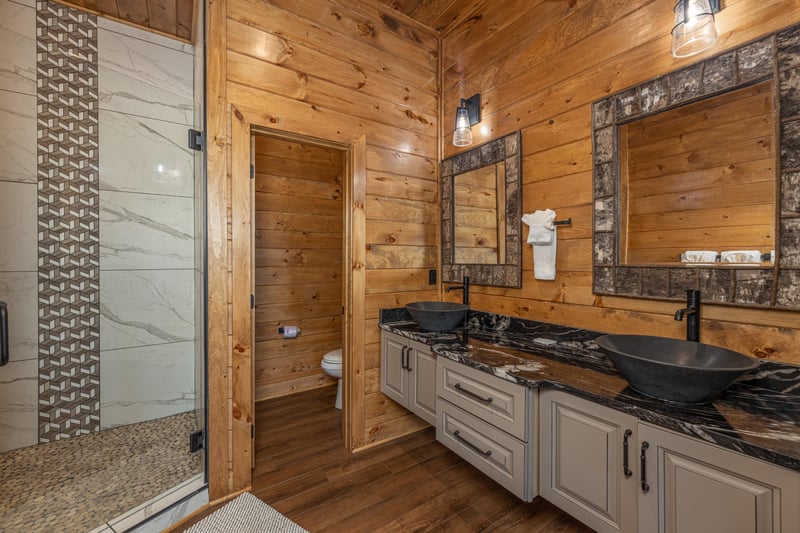 Bathroom with double vanity sinks and a large shower at Black Bears  Biscuits Lodge, a 6 bedroom cabin rental located in Pigeon Forge