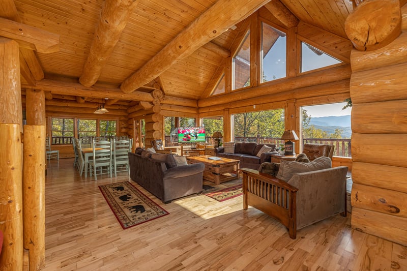 Vaulted living room with large windows at Grizzlys Den, a 5 bedroom cabin rental located in Gatlinburg