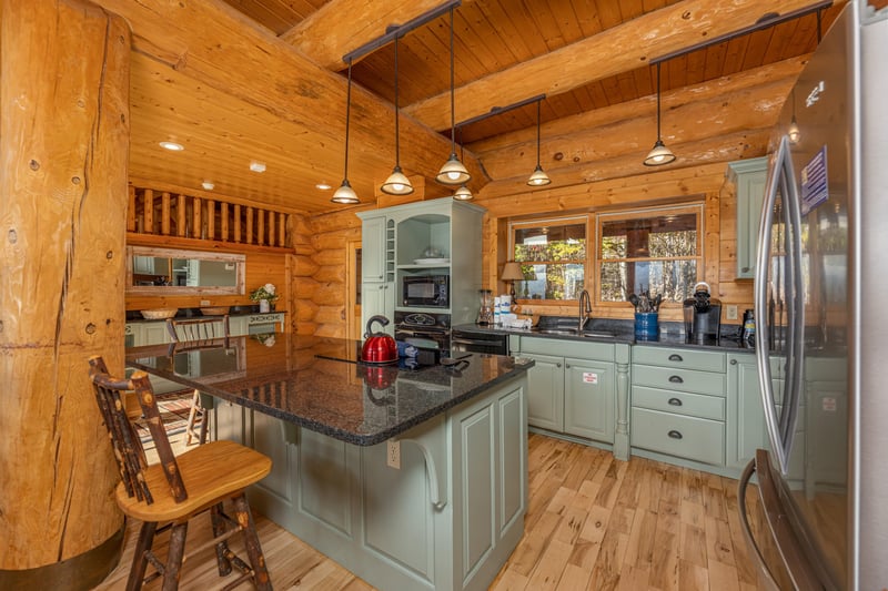 Kitchen island with granite top at Grizzlys Den, a 5 bedroom cabin rental located in Gatlinburg