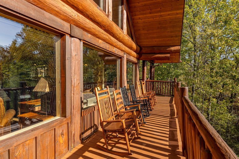 Rocking chairs on an open deck at Grizzlys Den, a 5 bedroom cabin rental located in Gatlinburg