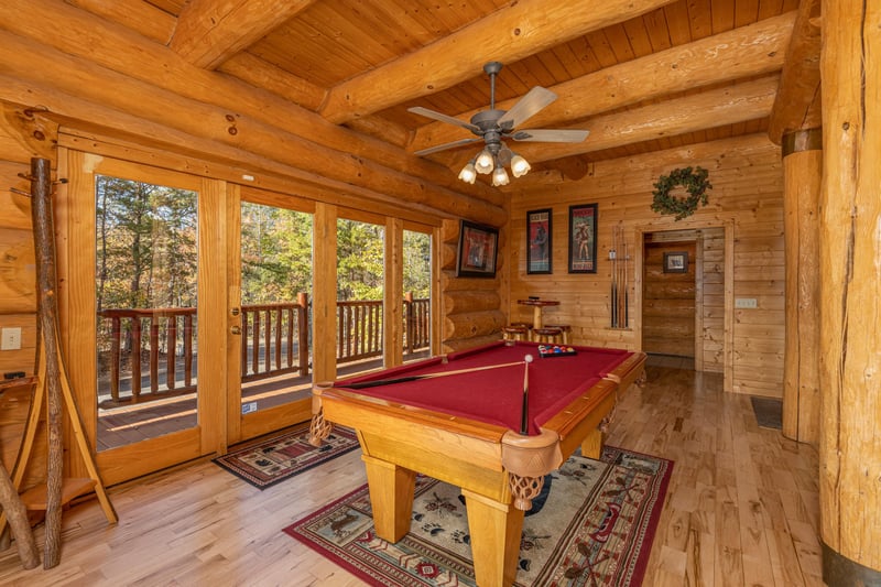 Red felt pool table at Grizzlys Den, a 5 bedroom cabin rental located in Gatlinburg