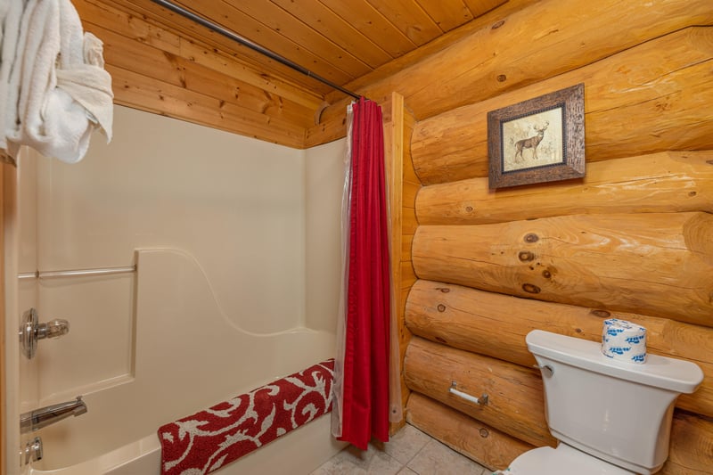 Bathroom with a tub and shower at Grizzlys Den, a 5 bedroom cabin rental located in Gatlinburg