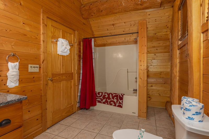 Bathroom with a tub and shower at Grizzlys Den, a 5 bedroom cabin rental located in Gatlinburg