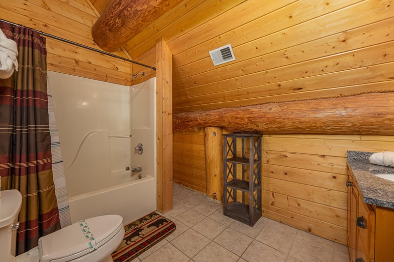 Bathroom with a tub and shower at Grizzlys Den, a 5 bedroom cabin rental located in Gatlinburg