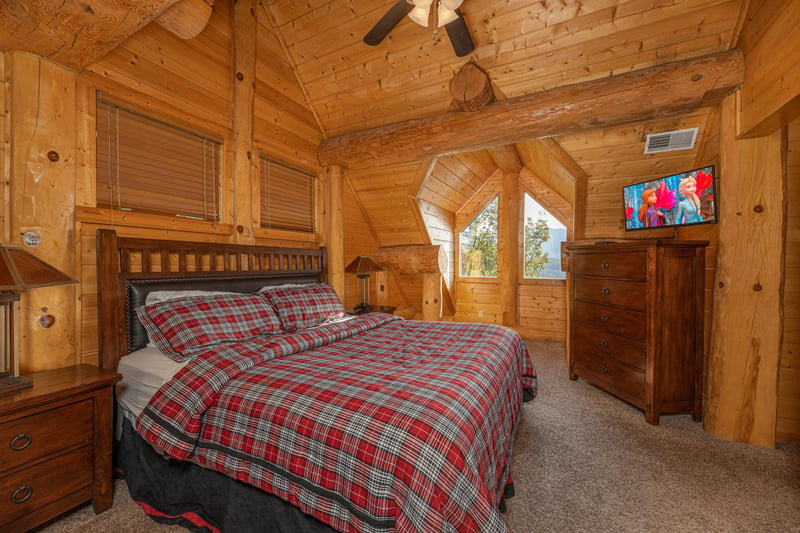 King bed, night stands, dresser, and TV in a bedroom at Grizzlys Den, a 5 bedroom cabin rental located in Gatlinburg